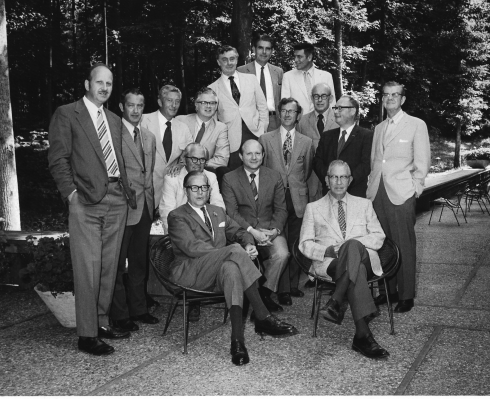 Colonial Williamsburg restoration specialists, probably late 1960s or early 1970s. Ivor Noël Hume is standing on the fair left. My father, George Alan Morledge, is seated in the center of the photo, where you can see that both of his hands are clasped loosely together.